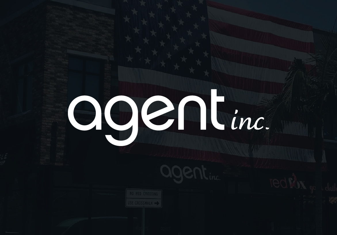 White AGENT INC. logo in sleek typography, set against a dark and subtly lit American flag background, representing their real estate services.