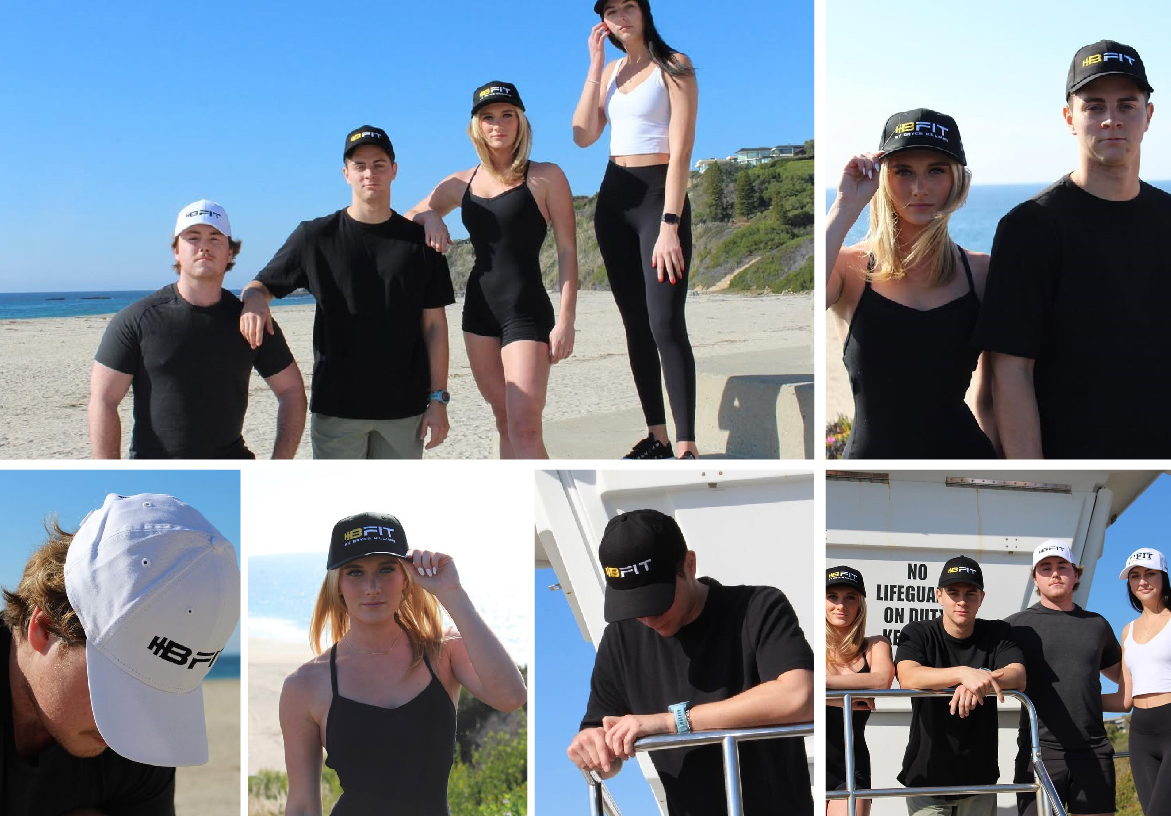 A group of athletes wearing B-FIT branded hats and gear on a sunny beach boardwalk, representing the brand's high-performance lifestyle.