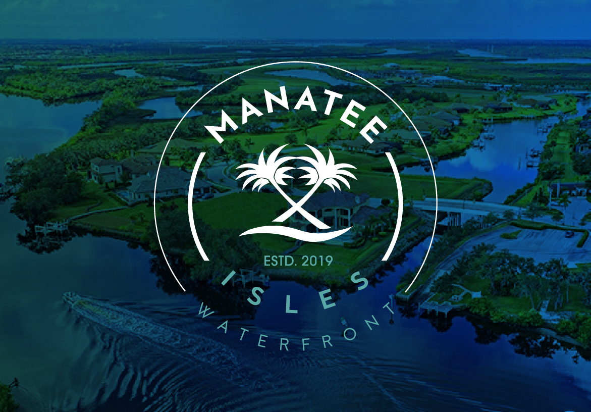 Manatee Isles Waterfront circular logo featuring crossed palm trees, overlaid on a twilight aerial view of the Florida townhouse community and canals.