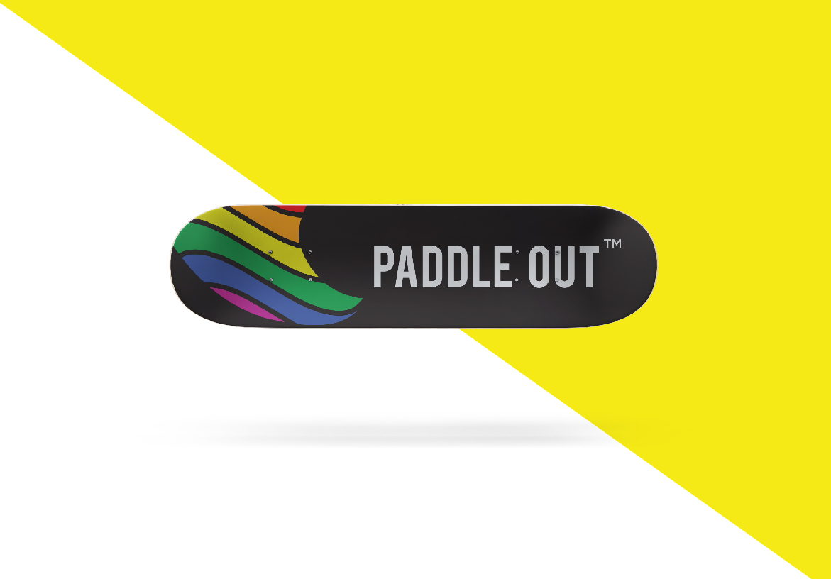 Skateboard deck design featuring the Paddle Out branding and rainbow stripes, displayed on a vibrant yellow background.
