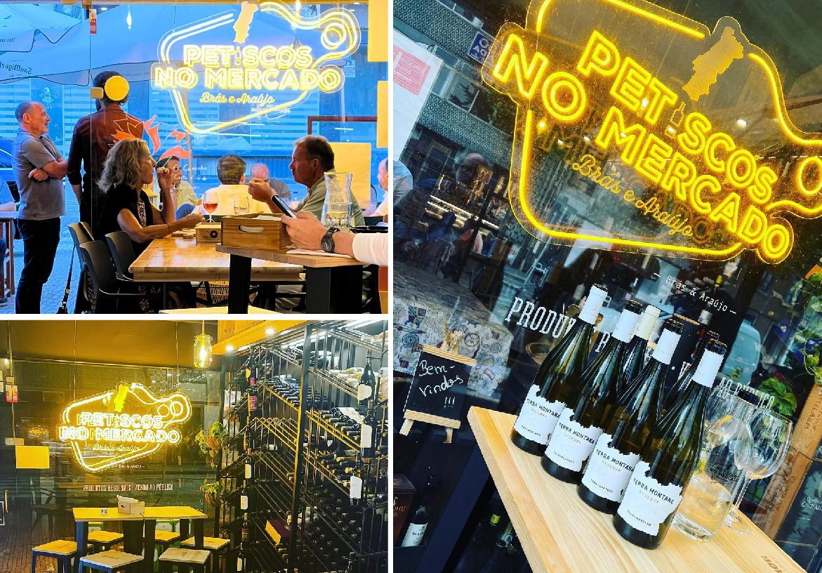 Lively atmosphere at Petiscos no Mercado in Matosinhos Market featuring customers dining, bright neon signage, and a display of Portuguese wine bottles on a wooden barrel.