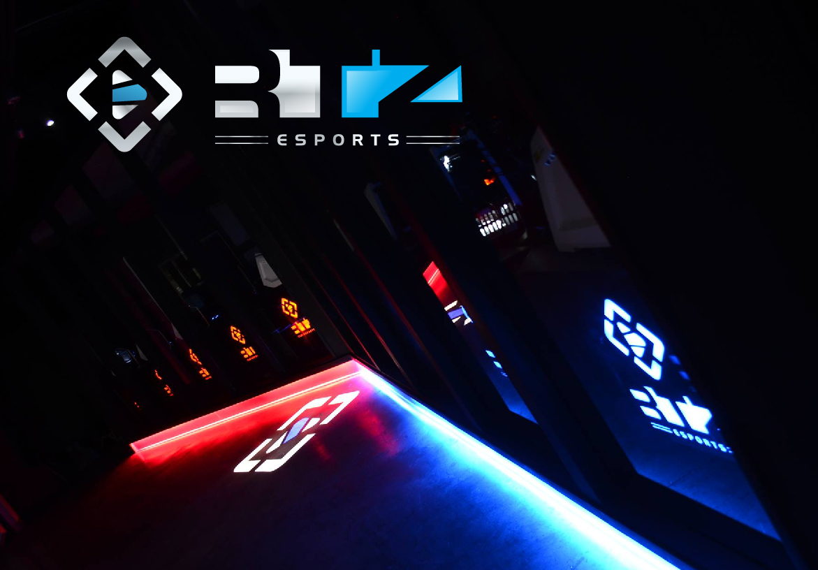 Atmospheric gaming event setup by RTZ Esports featuring red and blue neon lighting reflecting off high-performance computer stations.