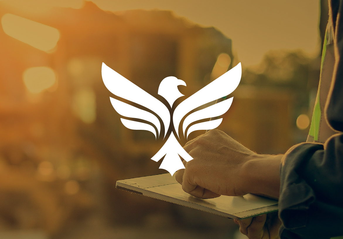 White eagle logo for Southern Standard Construction overlaid on a warm, golden-hour image of a site manager supervising heavy machinery.