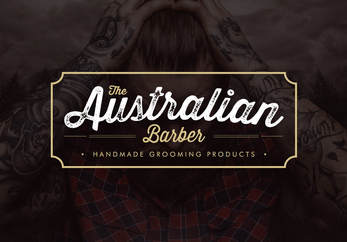Vintage script logo for The Australian Barber featuring gold typography, overlaid on a moody, dark background representing premium handmade grooming.