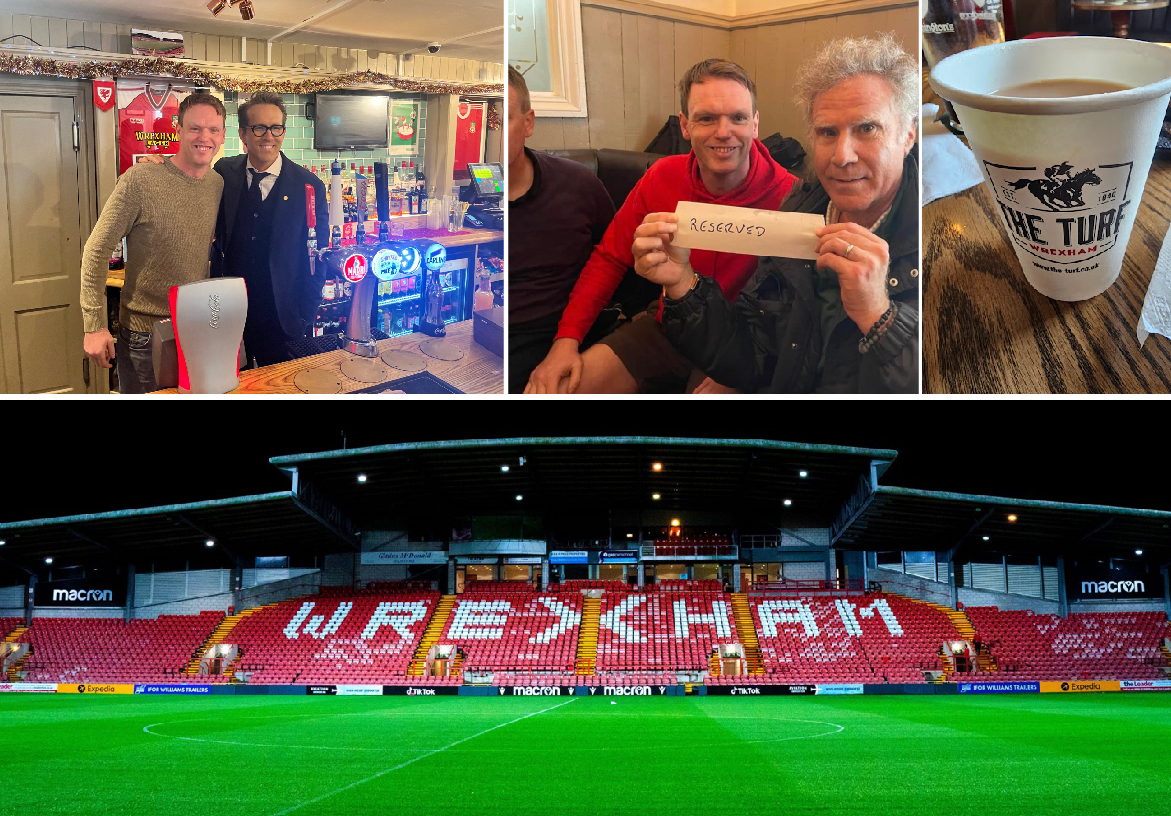 Wrexham AFC owners Ryan Reynolds and Rob McElhenney visiting The Turf pub, posed with landlord Wayne Jones and holding branded merchandise.