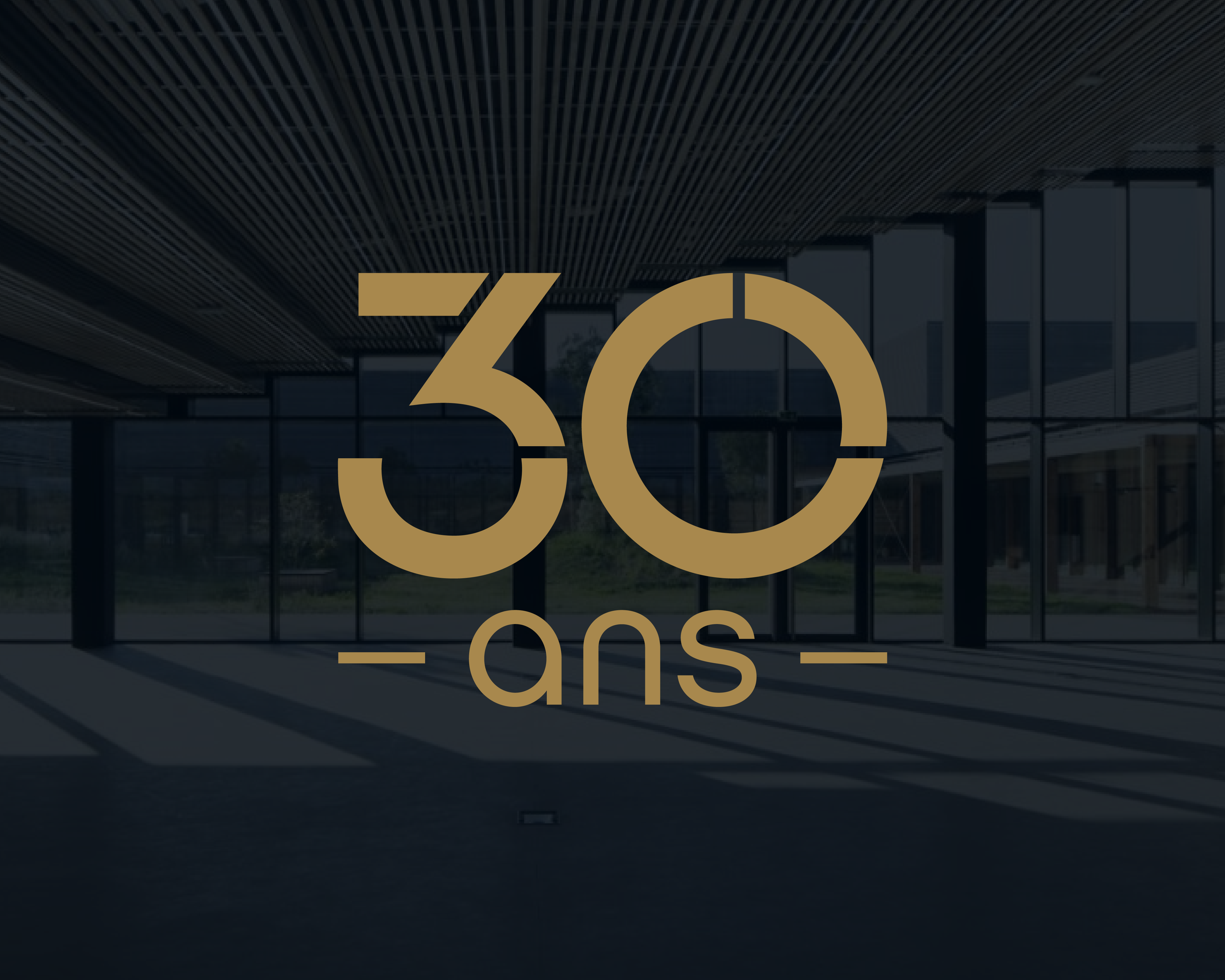 Gold 30 years anniversary mark placed over dark architectural photography