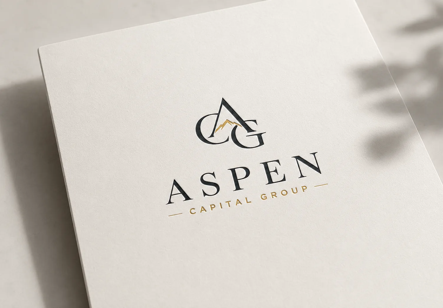Aspen Capital Group gold AGC monogram logo on a dark lobby reception wall