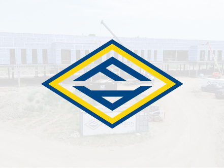 Fogel Anderson diamond logo icon featuring the 'FA' monogram in blue and yellow, overlaid on a large commercial construction site background.