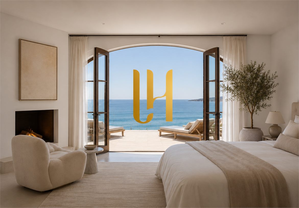 Lauren Halcovich LH monogram framed by a luxury bedroom with open doors to an ocean view