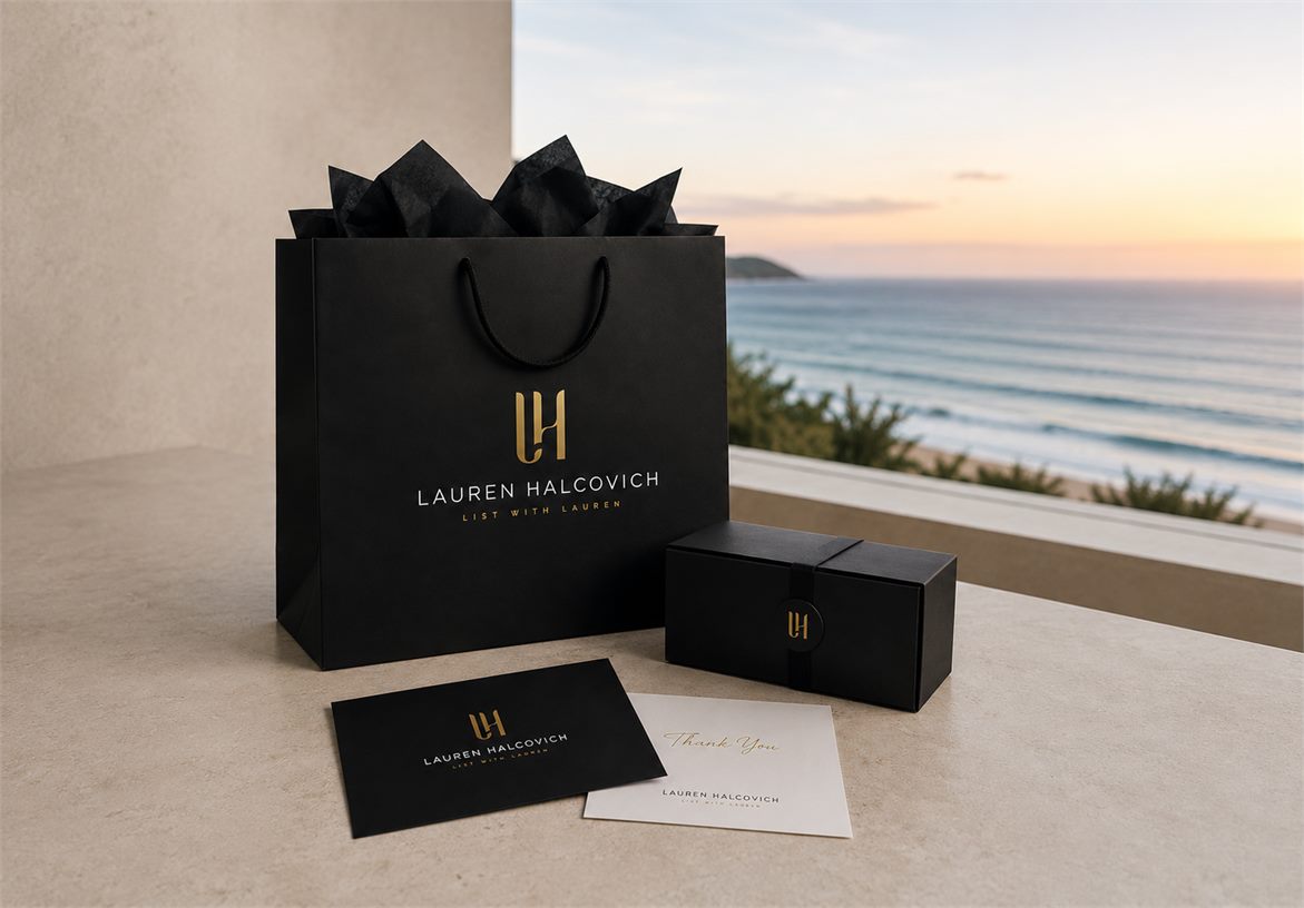 Lauren Halcovich luxury client gift packaging with branded bag and collateral overlooking the coast