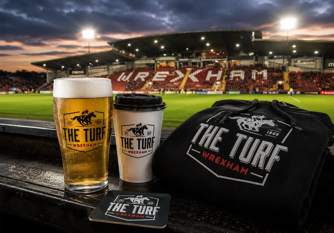 The Turf branded pint, coffee cup, and hoodie at Wrexham Racecourse Ground