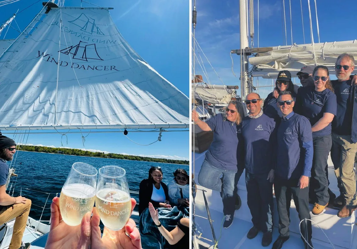 Guests enjoying a luxury sailing experience on the Wind Dancer with champagne glasses against a backdrop of blue water
