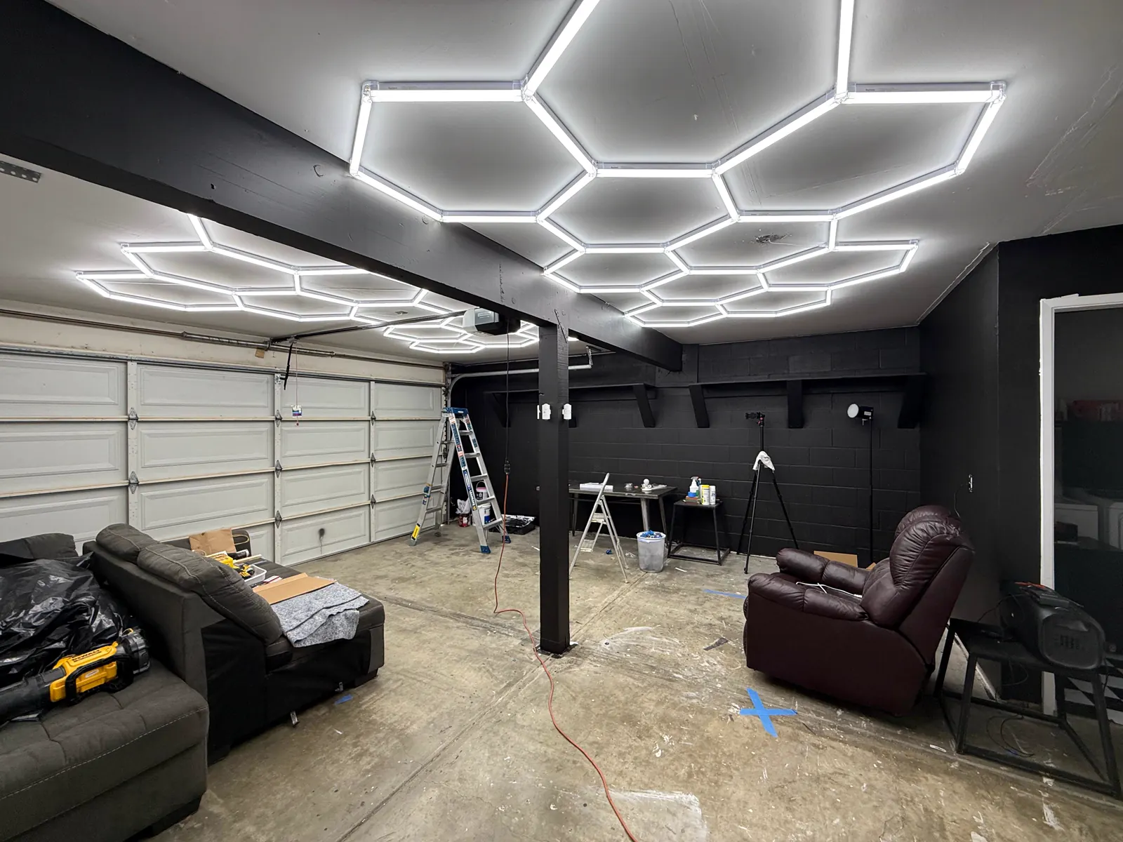Wide view of the Wake Up Sports studio buildout with lighting and wall preparation in progress