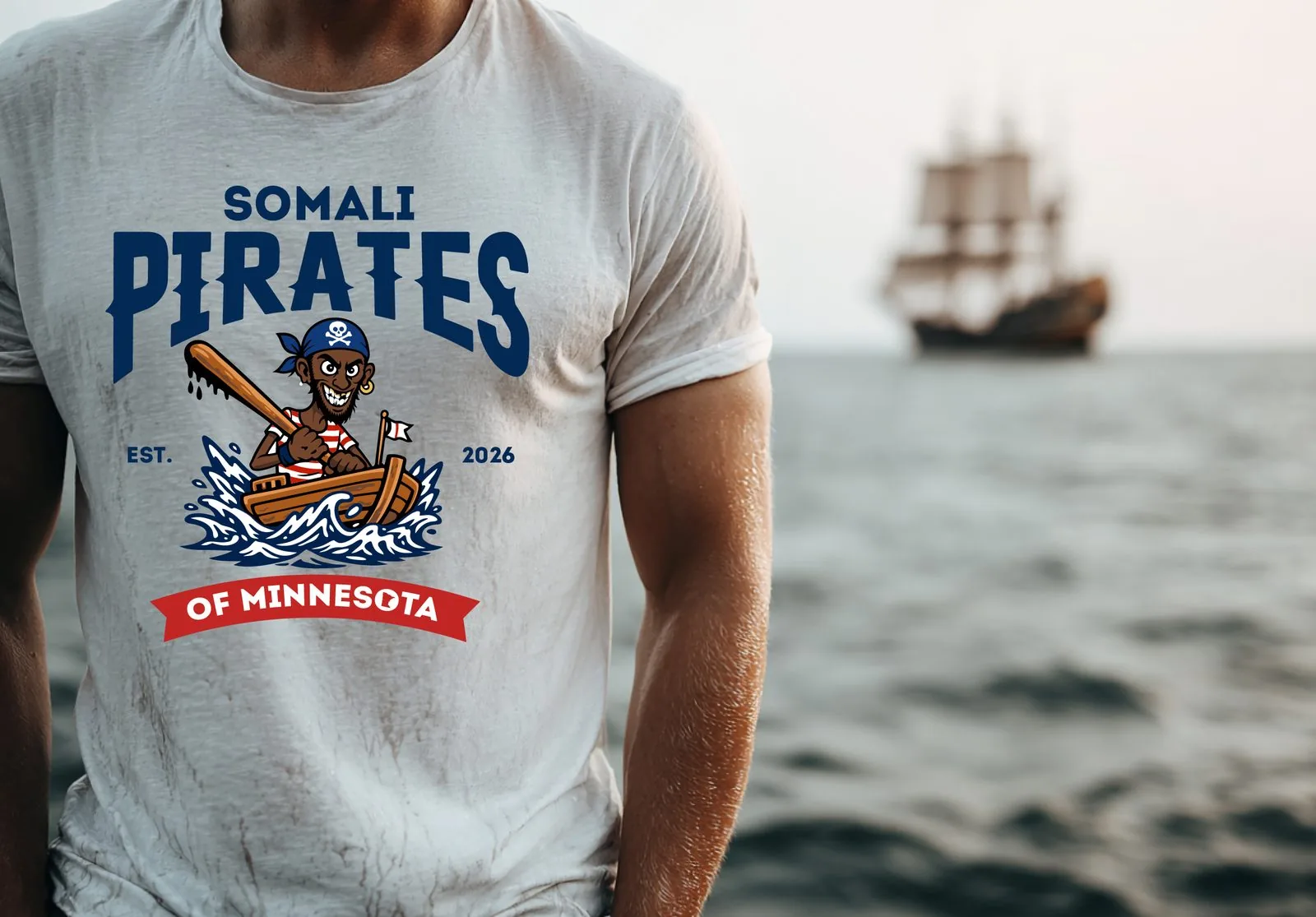 Model wearing Somali Pirates tee by the ocean with tall ship